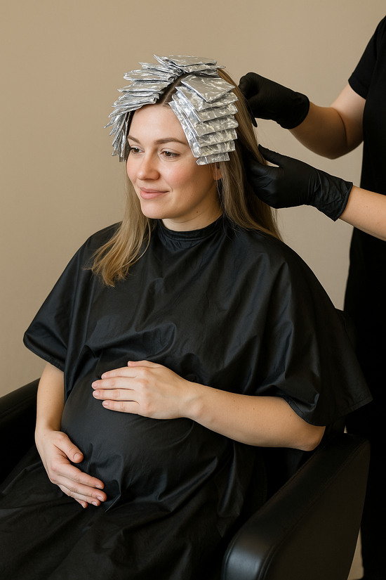Pregnant woman with foils in hair during safe low-tox salon colour service.