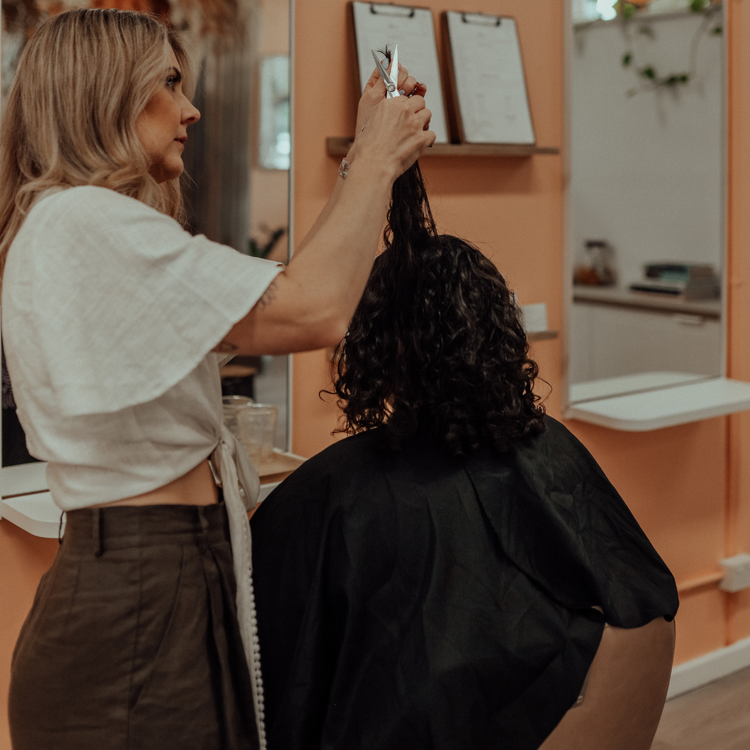 Curly-haired client receiving personalised curl consultation at Ardor Organics